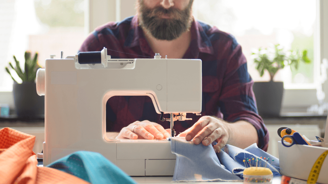 man using sewing machine