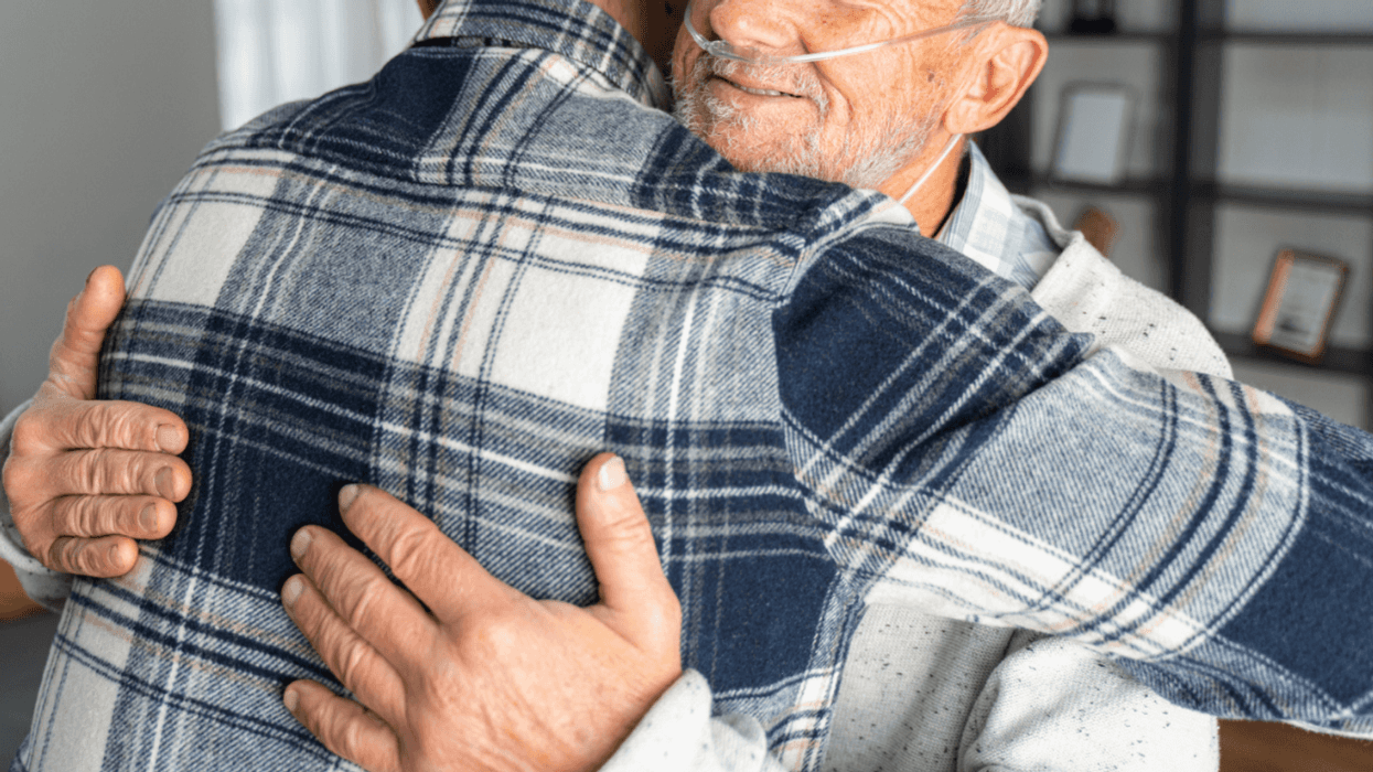 Man with cancer hugging loved one