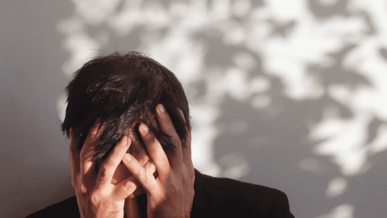 Man with his head in his hands.