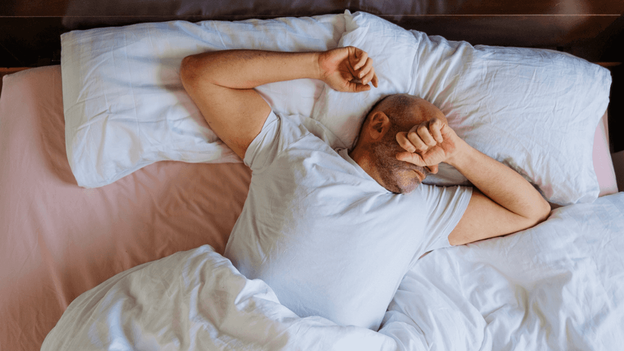 Man with pillow in bed