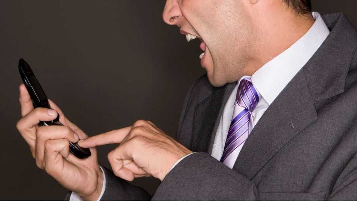 Man yelling at his mobile phone.