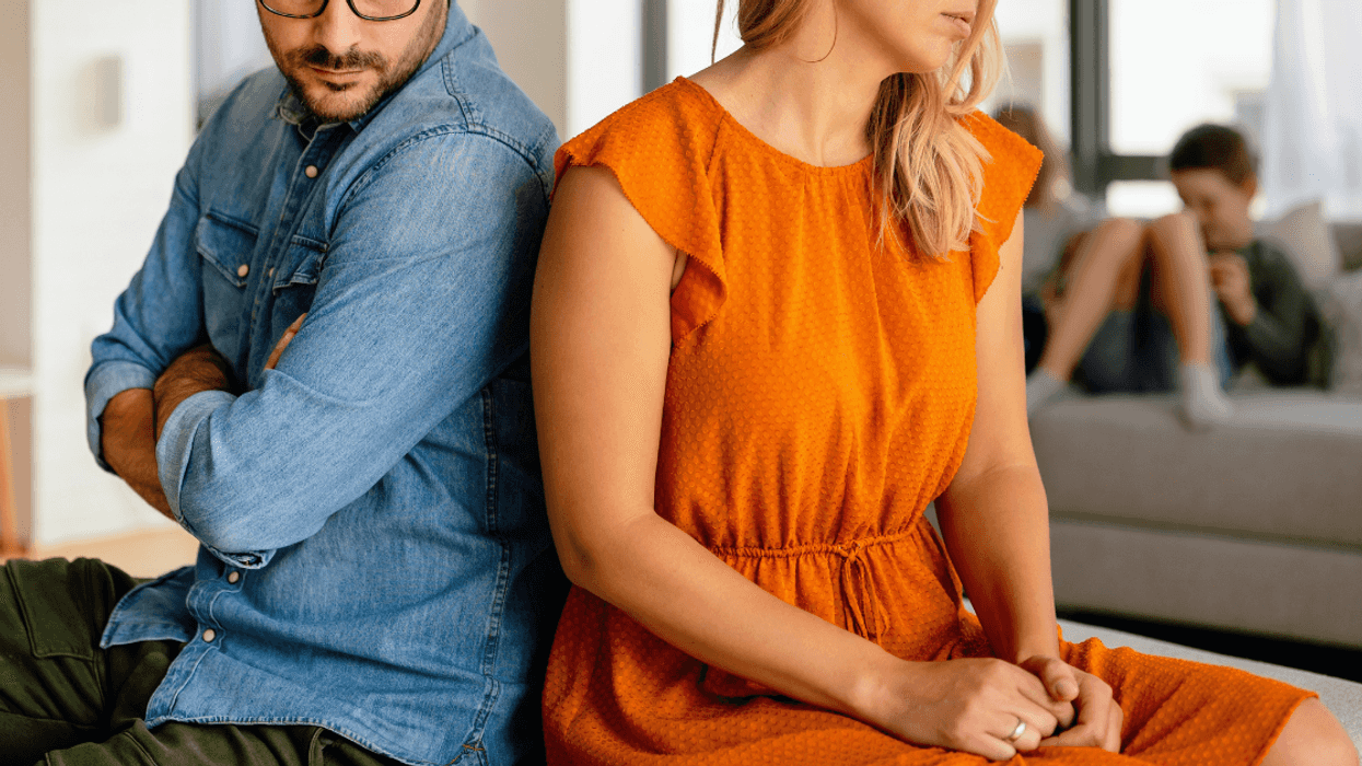 married couple disagree while children are in the background