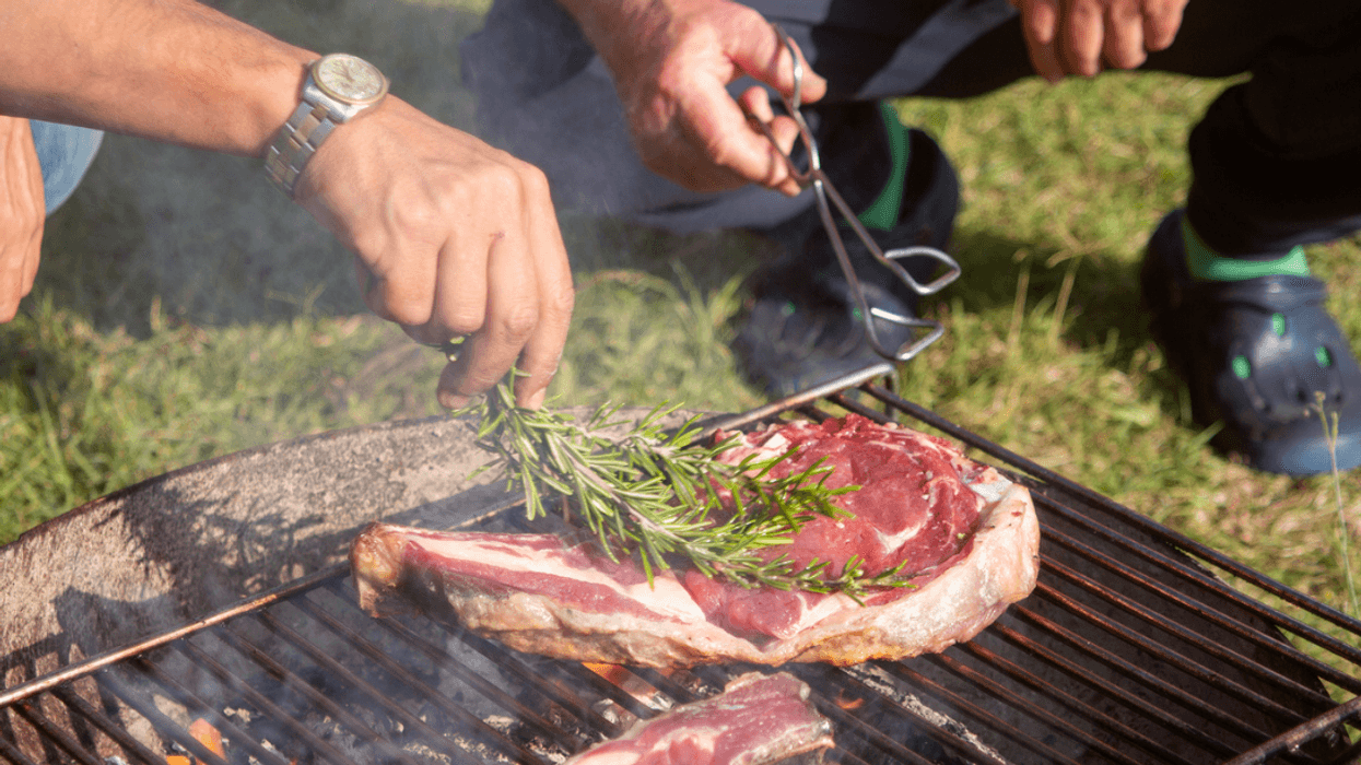 Men grilling steaks