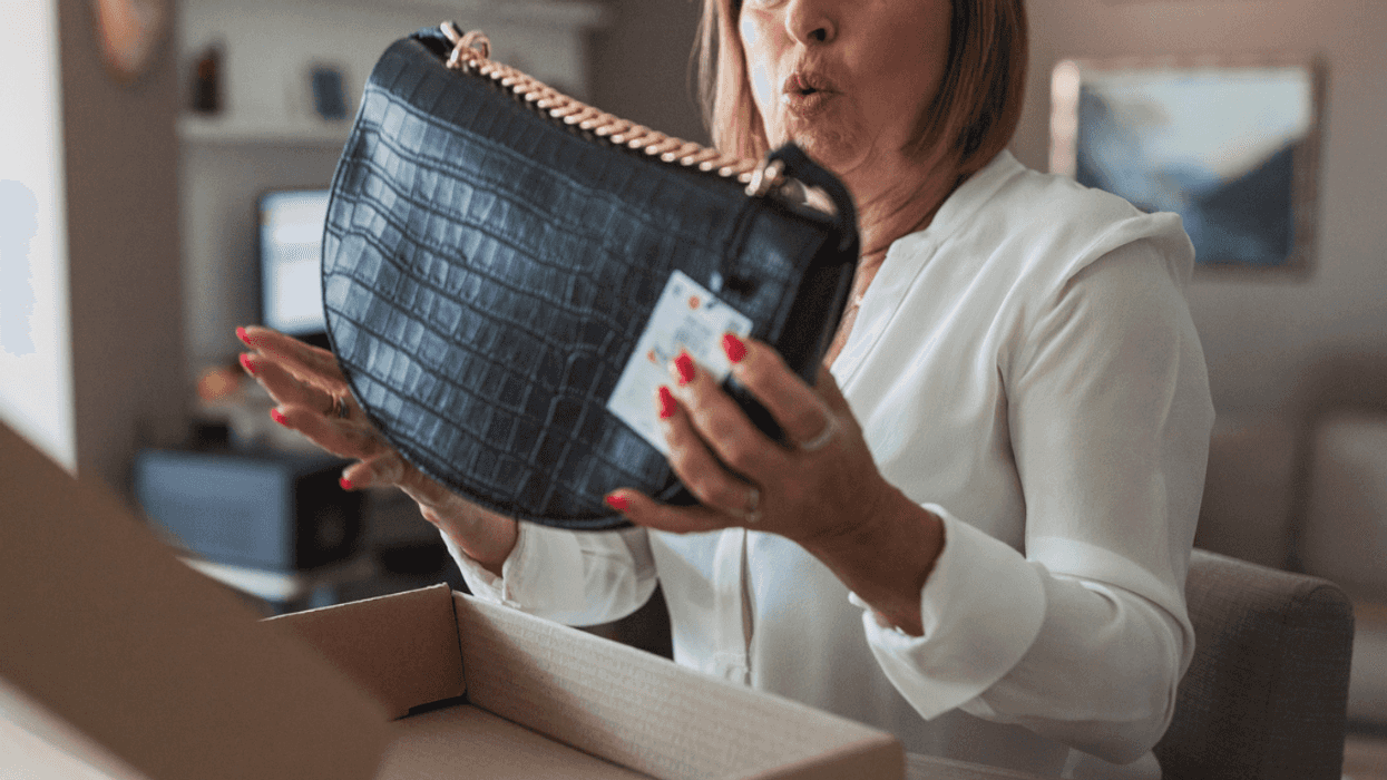 Middle-aged woman admiring an expensive purse