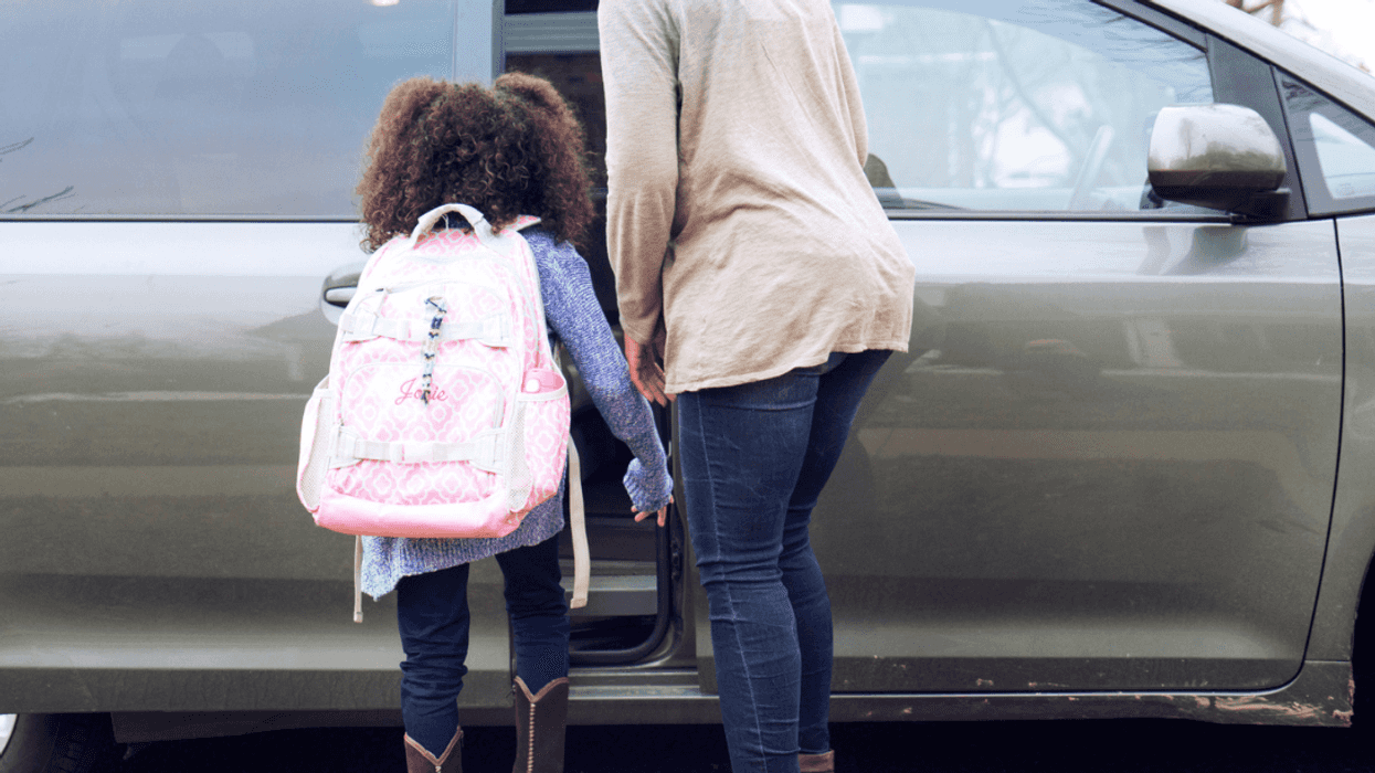 Mom driving her daughter to school