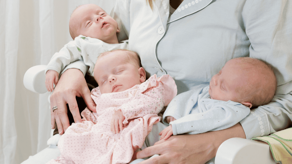 Mom holding triplets