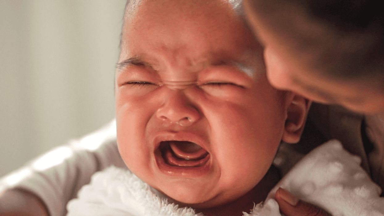 mother comforting crying baby
