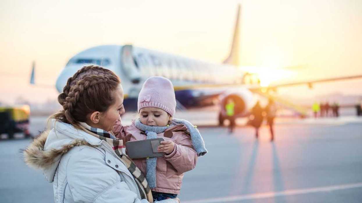 Mother holding a baby at the airport