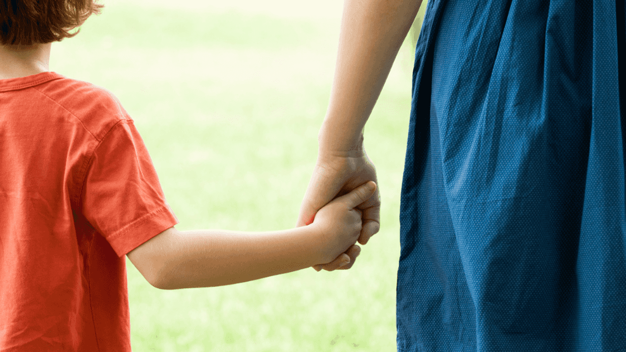 Mother holding young boy’s hand