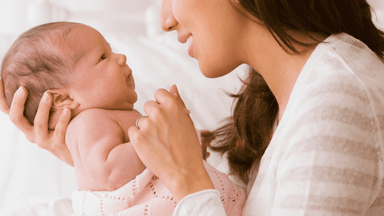 New mom at home with her newborn baby