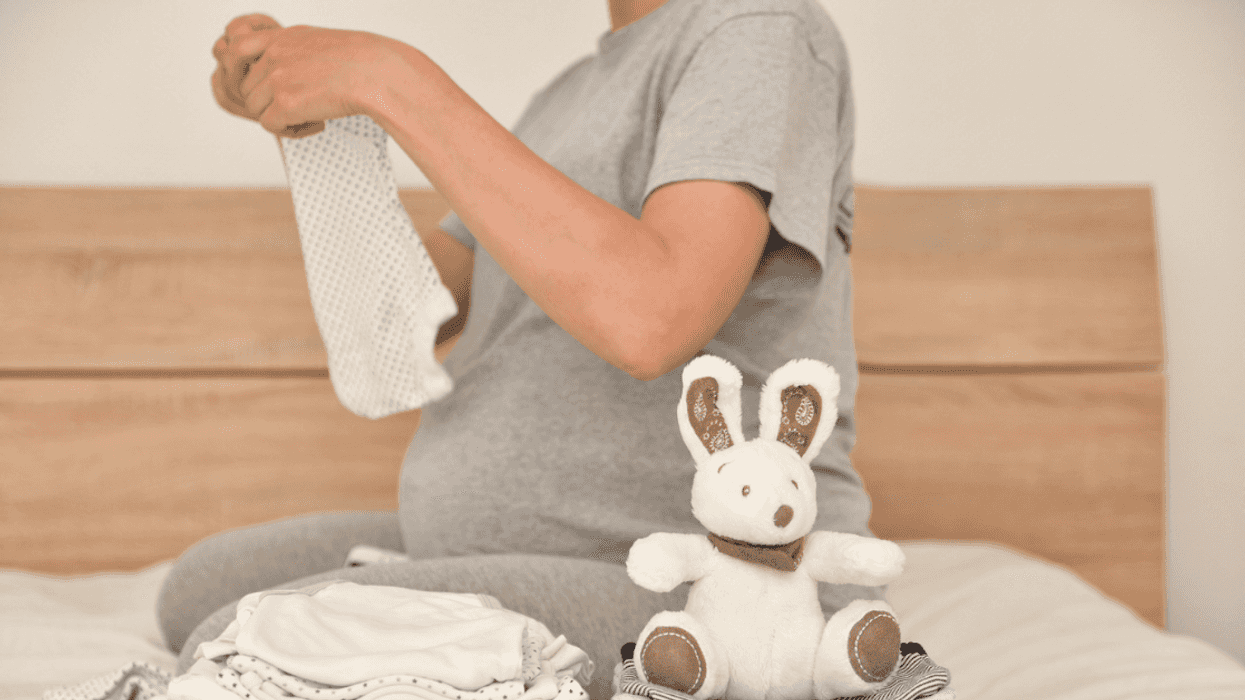 New mom folding baby clothes