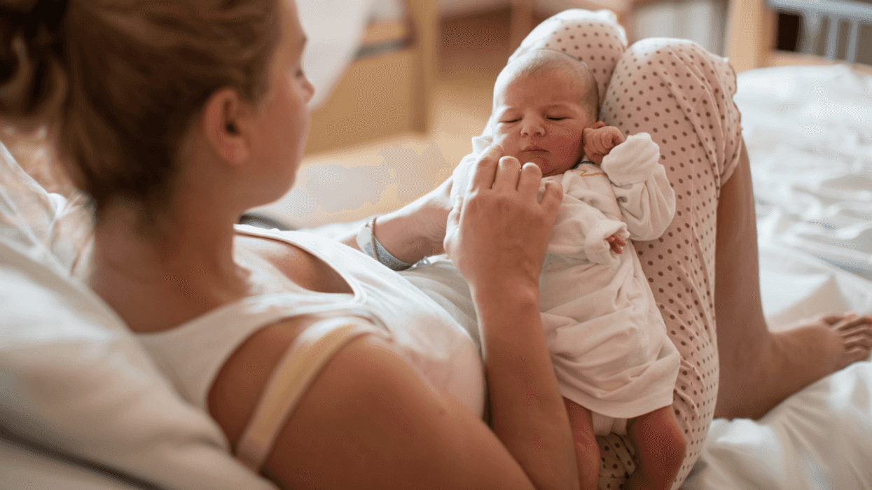 New mom with newborn baby on lap