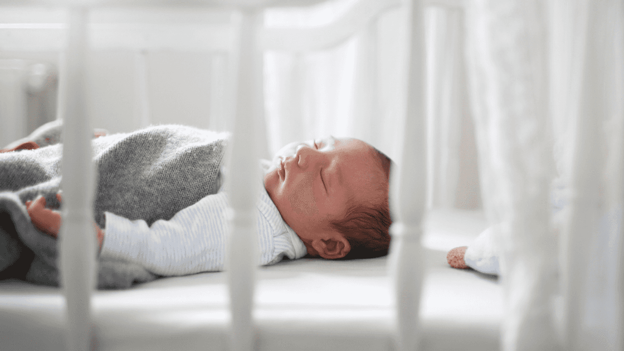 Newborn baby sleeping in their crib