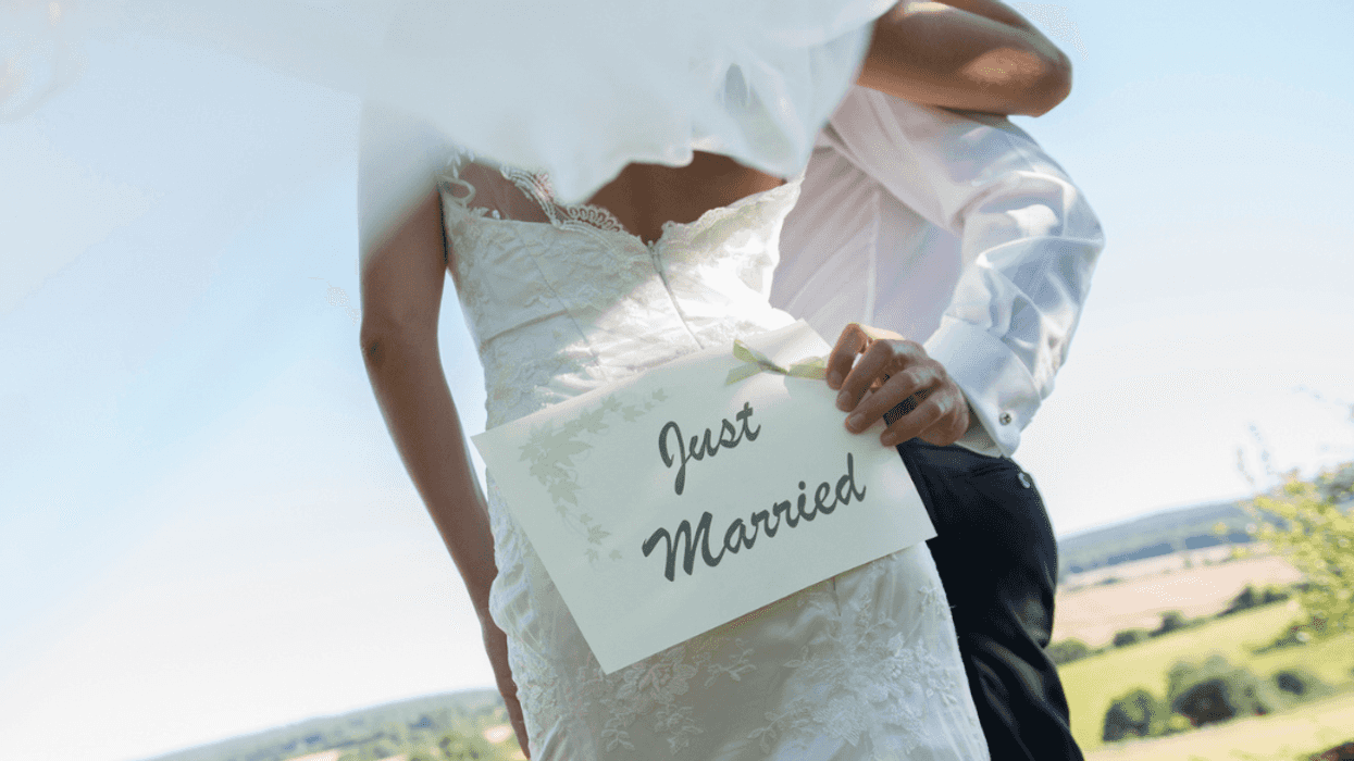 Newly married couple standing on a beautiful property