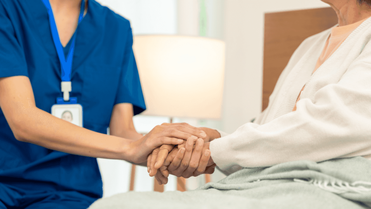 nurse holding patient's hand