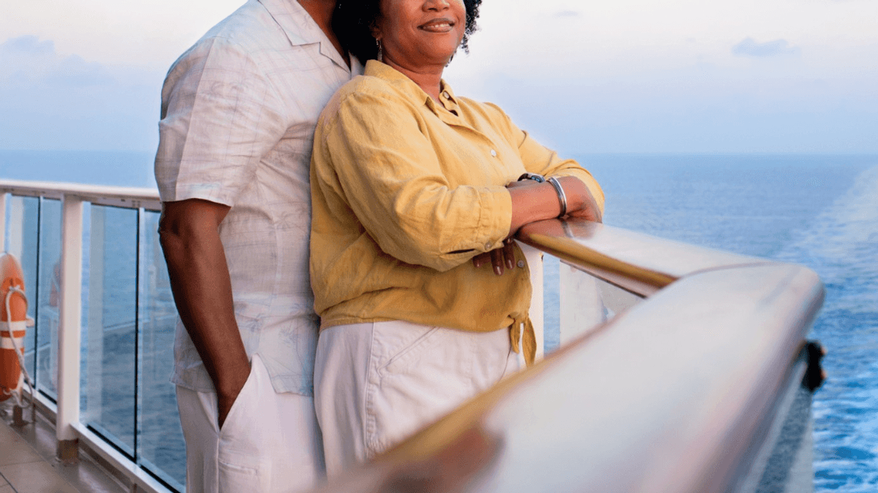 older couple standing on deck of cruise ship