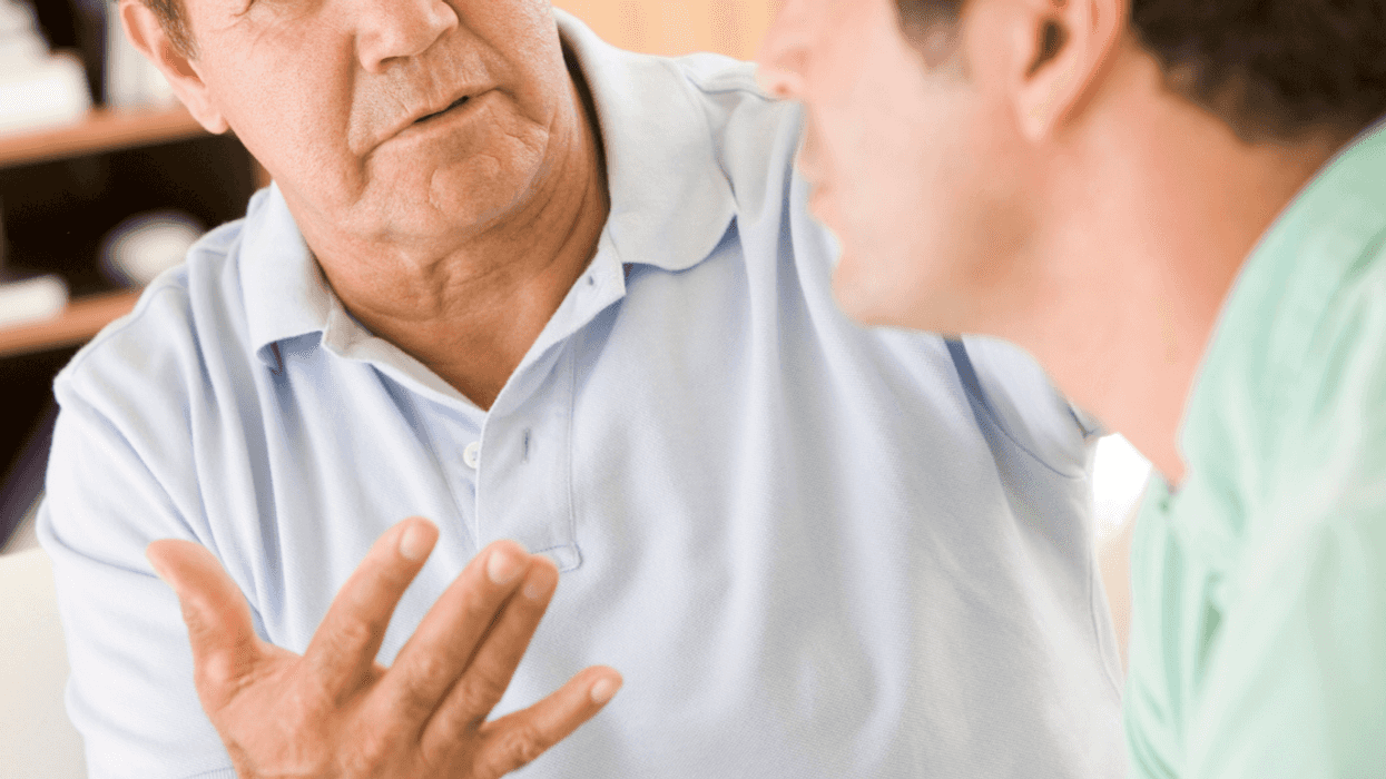 Older man arguing with younger man