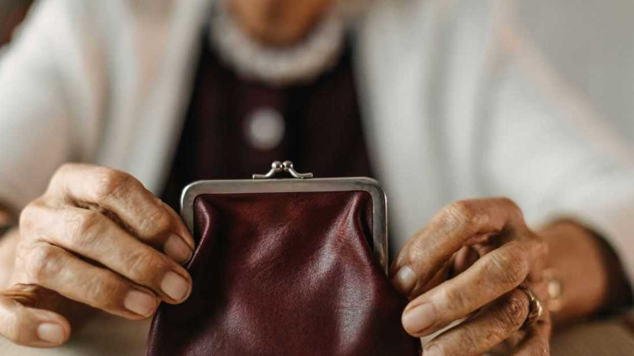 Older woman counting coins from her wallet