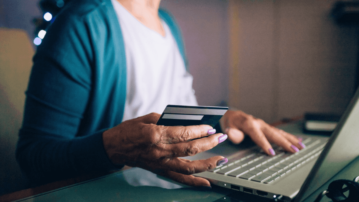 older woman entering credif card information online