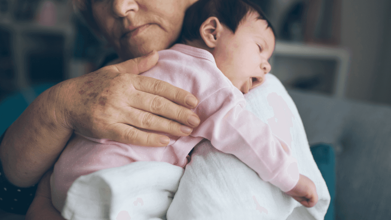 older woman holding young infant