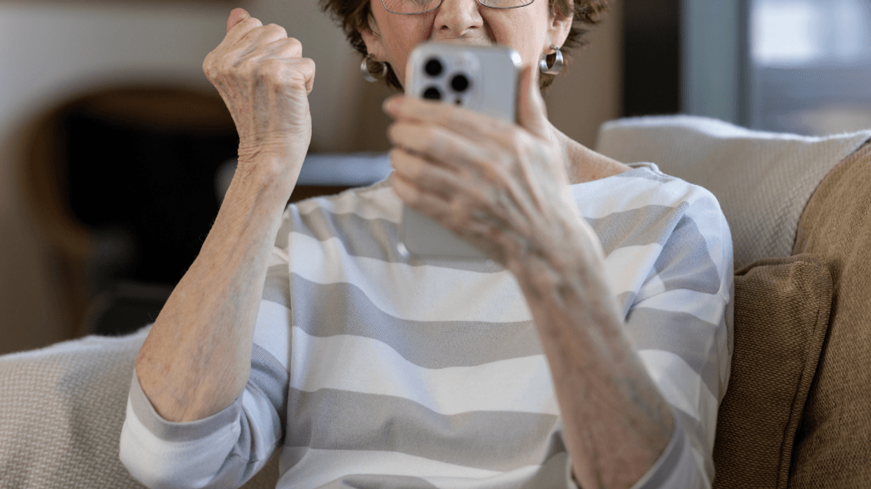 older woman looking angrily at her phone