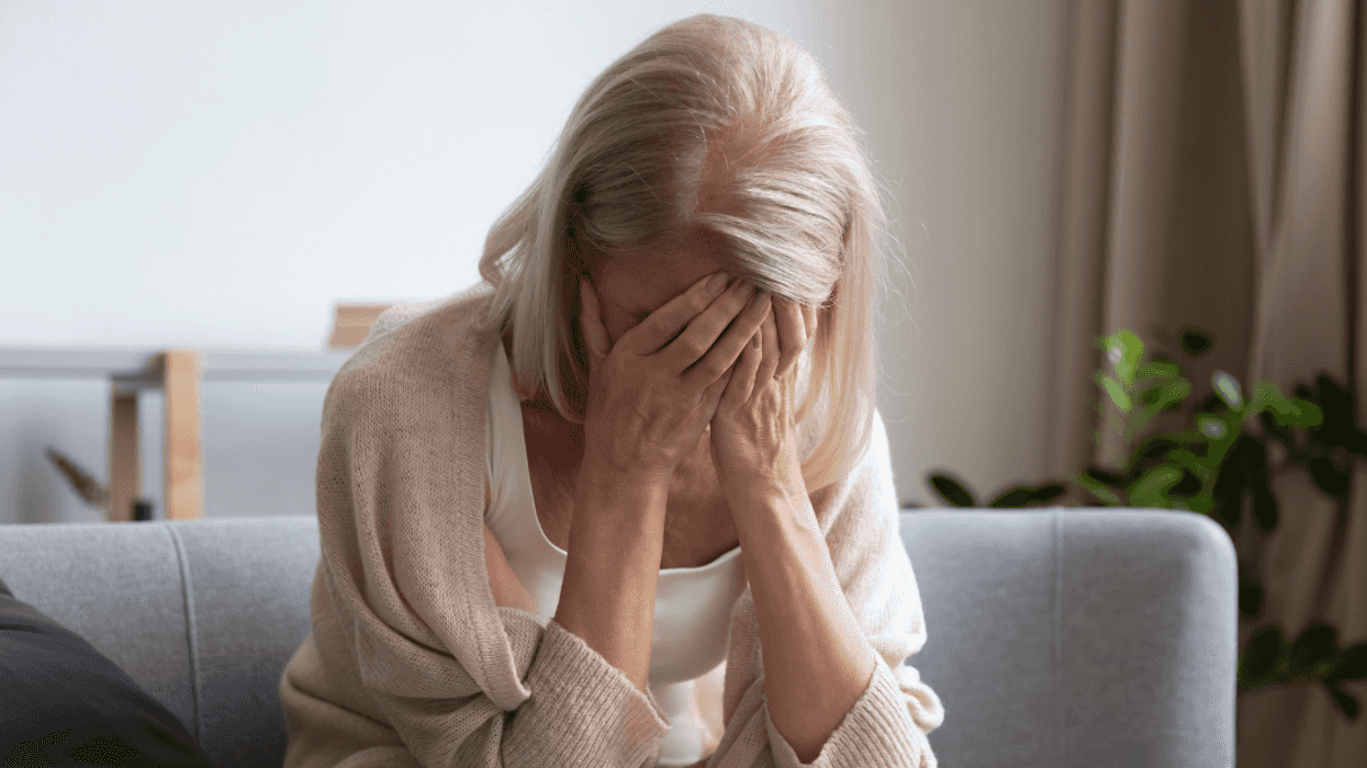 older woman with head in hands