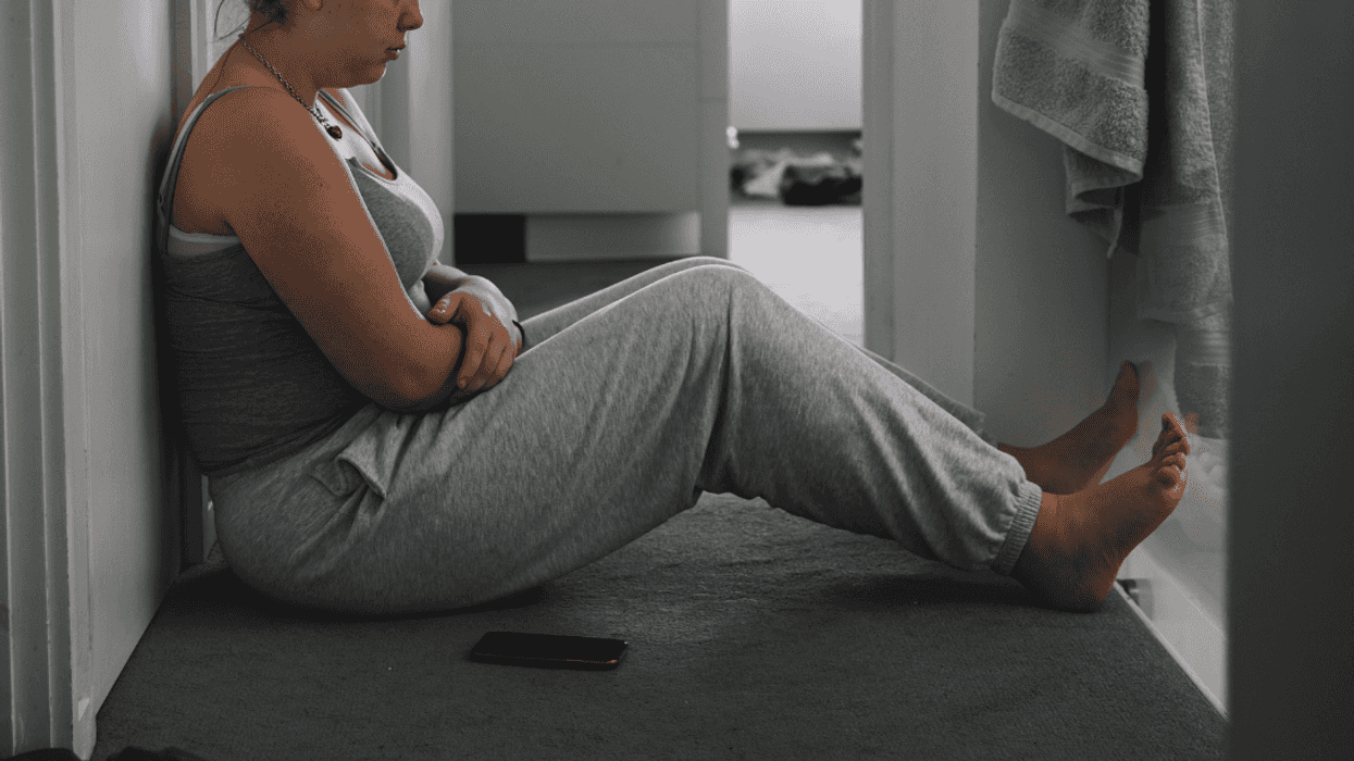overweight teen girl seated on floor