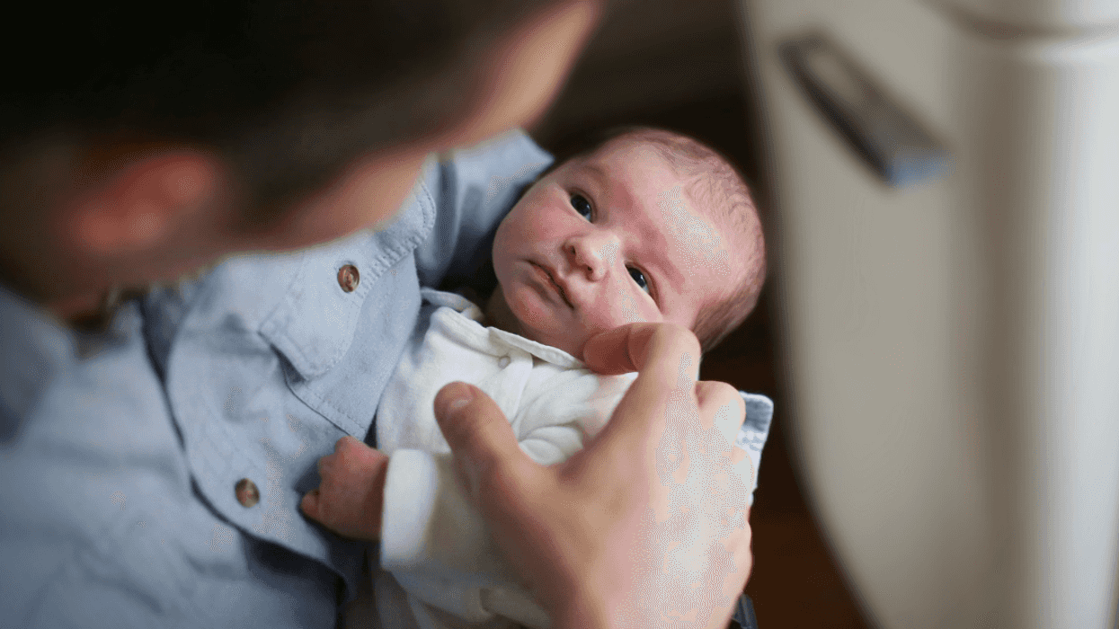 parent holding newborn baby