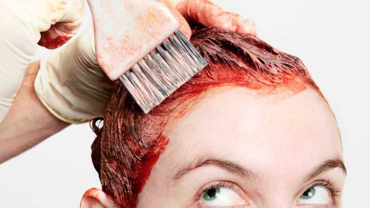 Permanent hair dye being applied with a watchful eye.