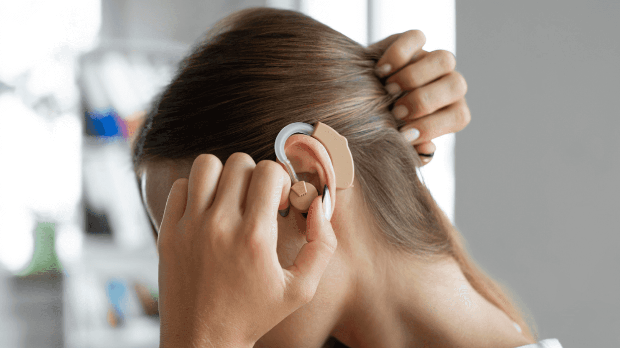 Person adjusting hearing aids
