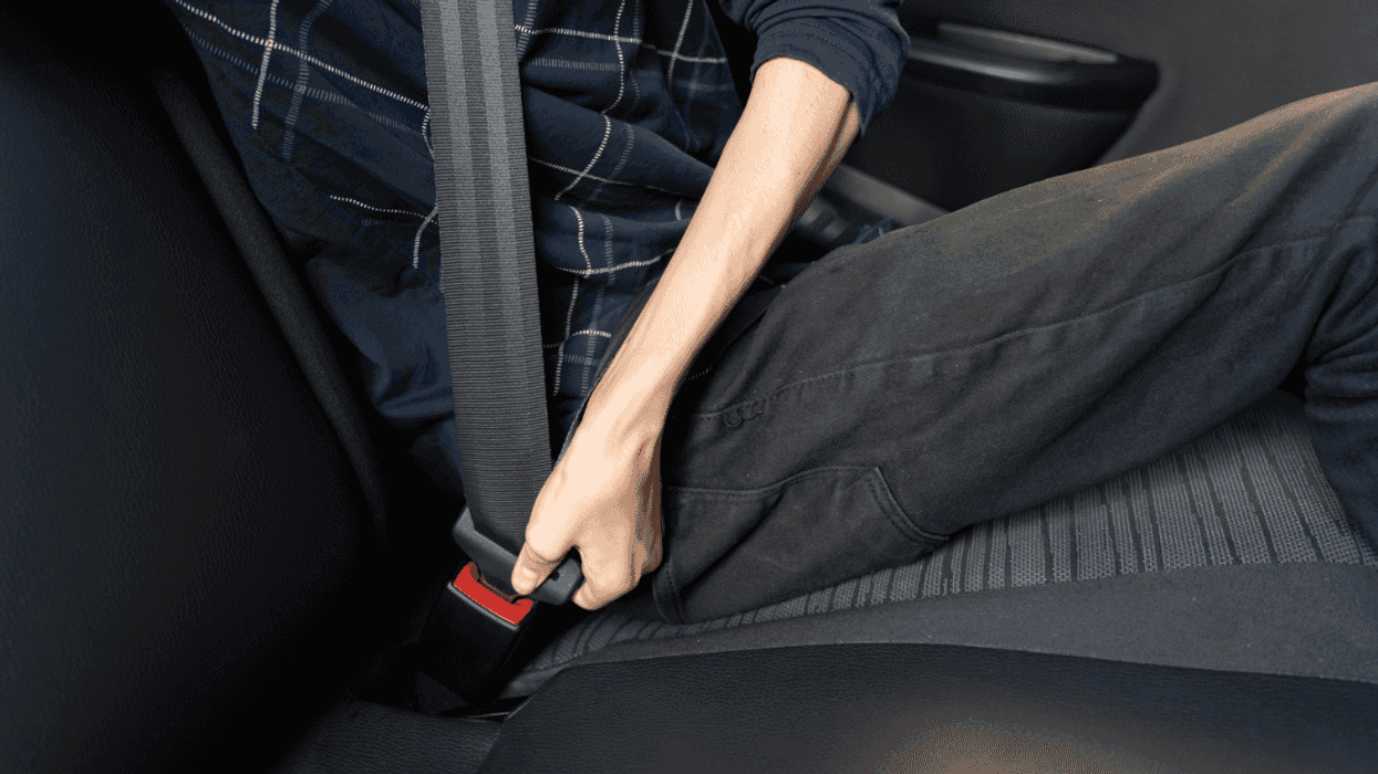 Person buckling their seatbelt