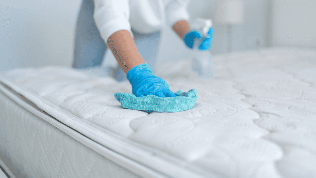 person cleaning mattress