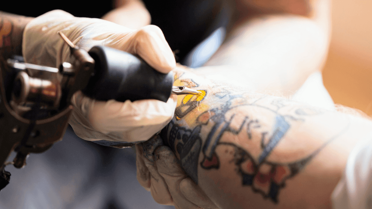 person getting detailed tattoo on arm