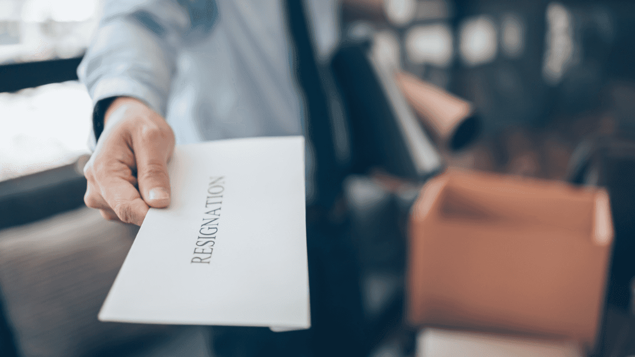 person handing in a resignation letter