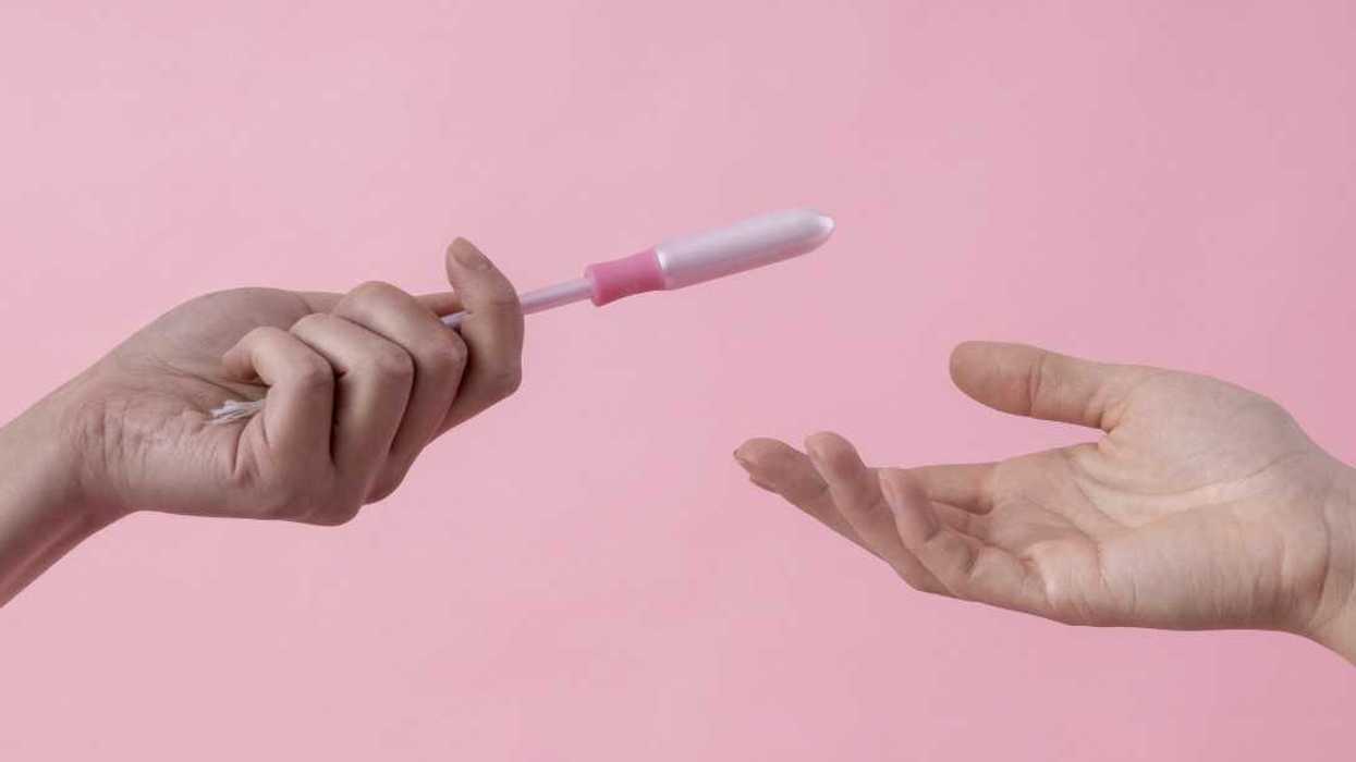 person handing tampon to another person