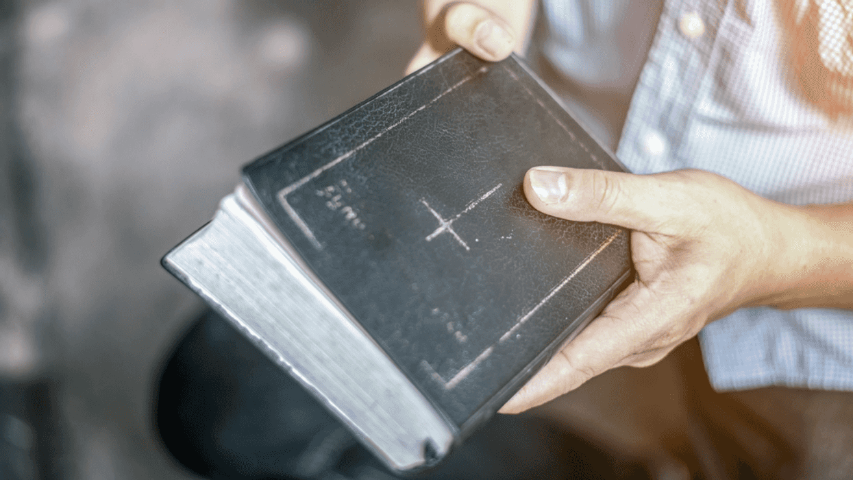 Person holding a Bible