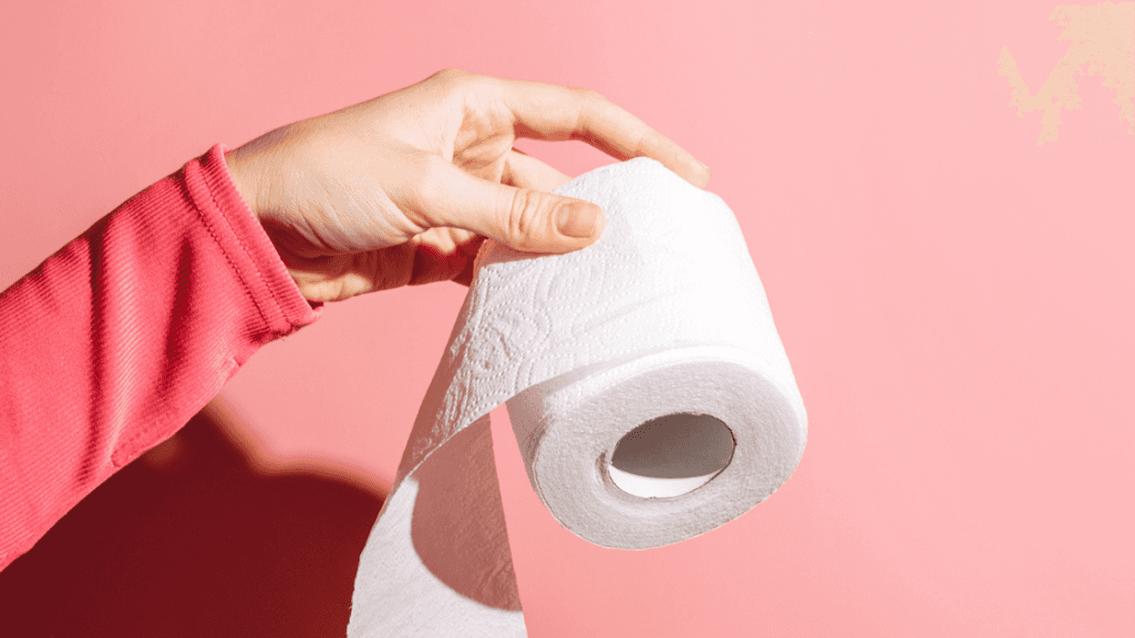 Person holding a roll of toilet paper