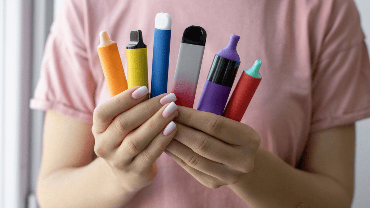 person holding multiple vape pens