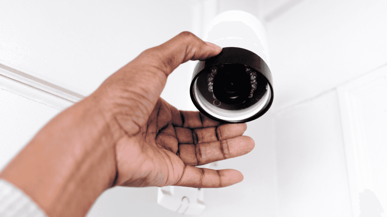 Person installing in-home security cameras