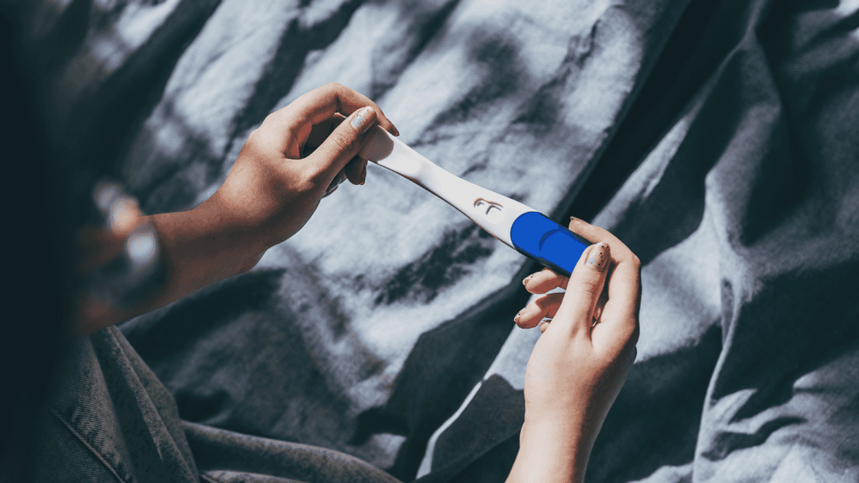 person looking at pregnancy test