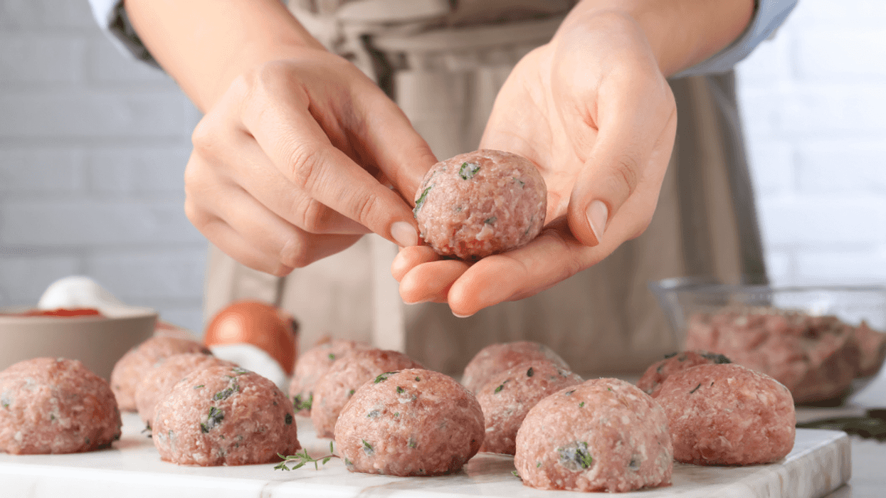 person making meatballs