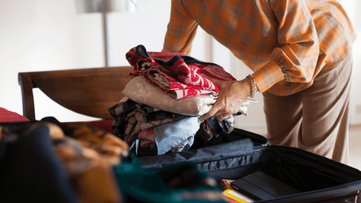 Person packing a suitcase