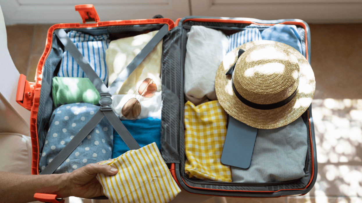 person packing suitcase