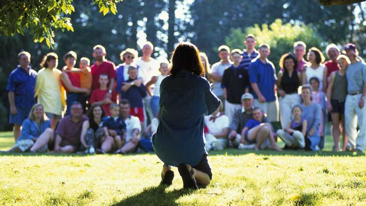 Person setting up to take group photo