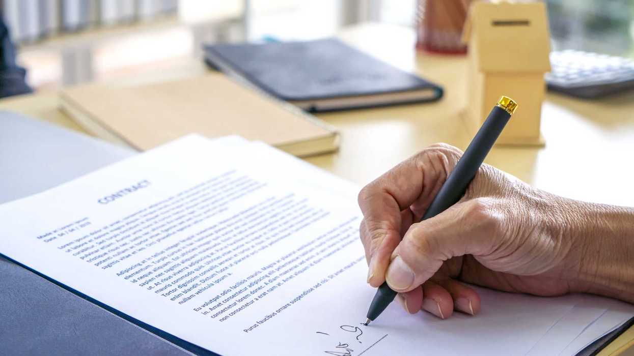 Person signing life insurance paperwork