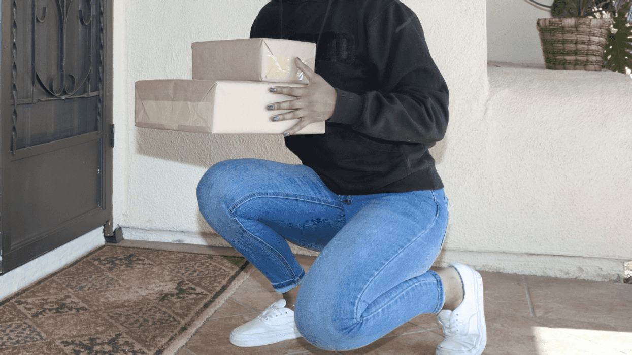 person stealing packages from someone's doorstep