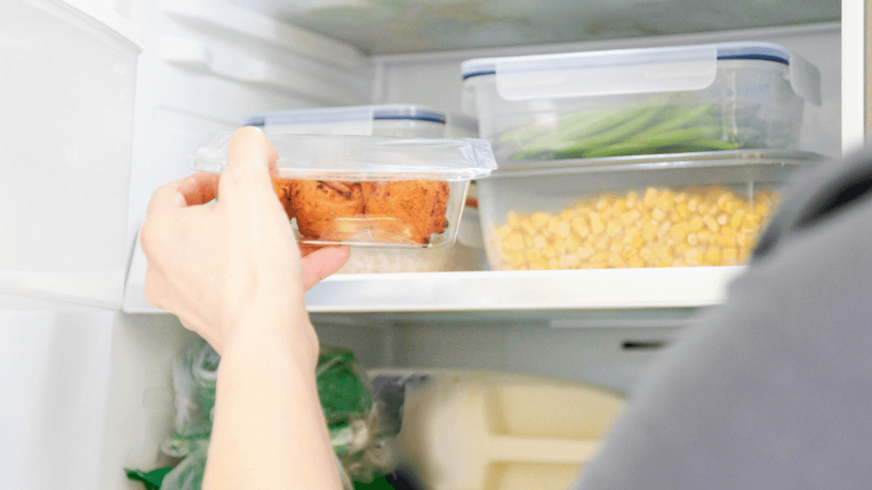 Person taking leftovers out of the fridge