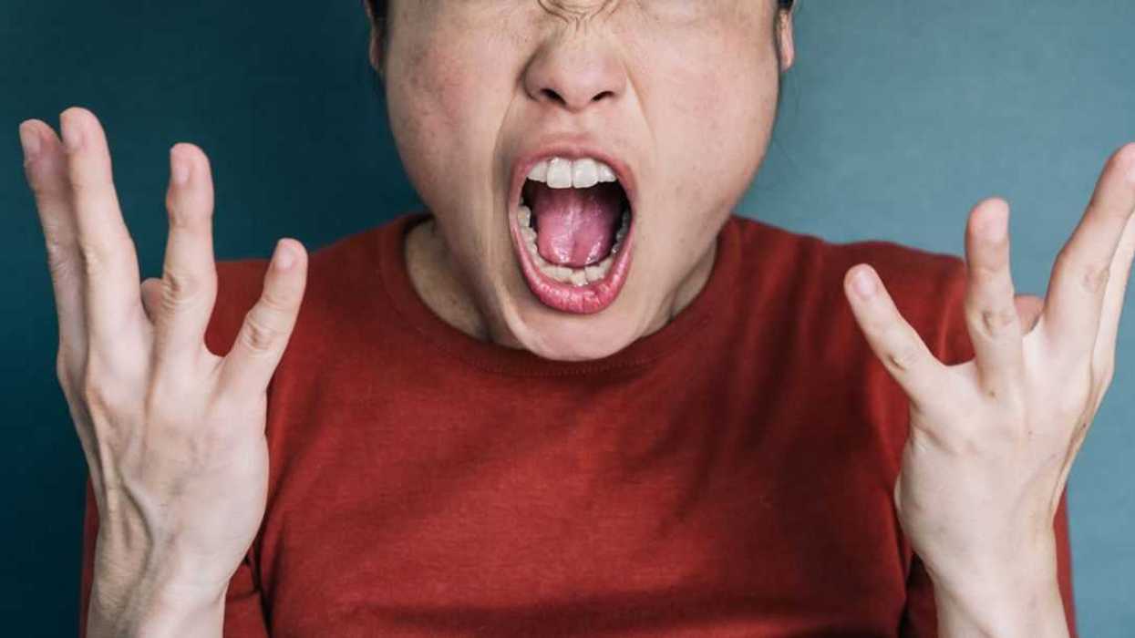 Portrait of a woman shouting and looking into a camera.