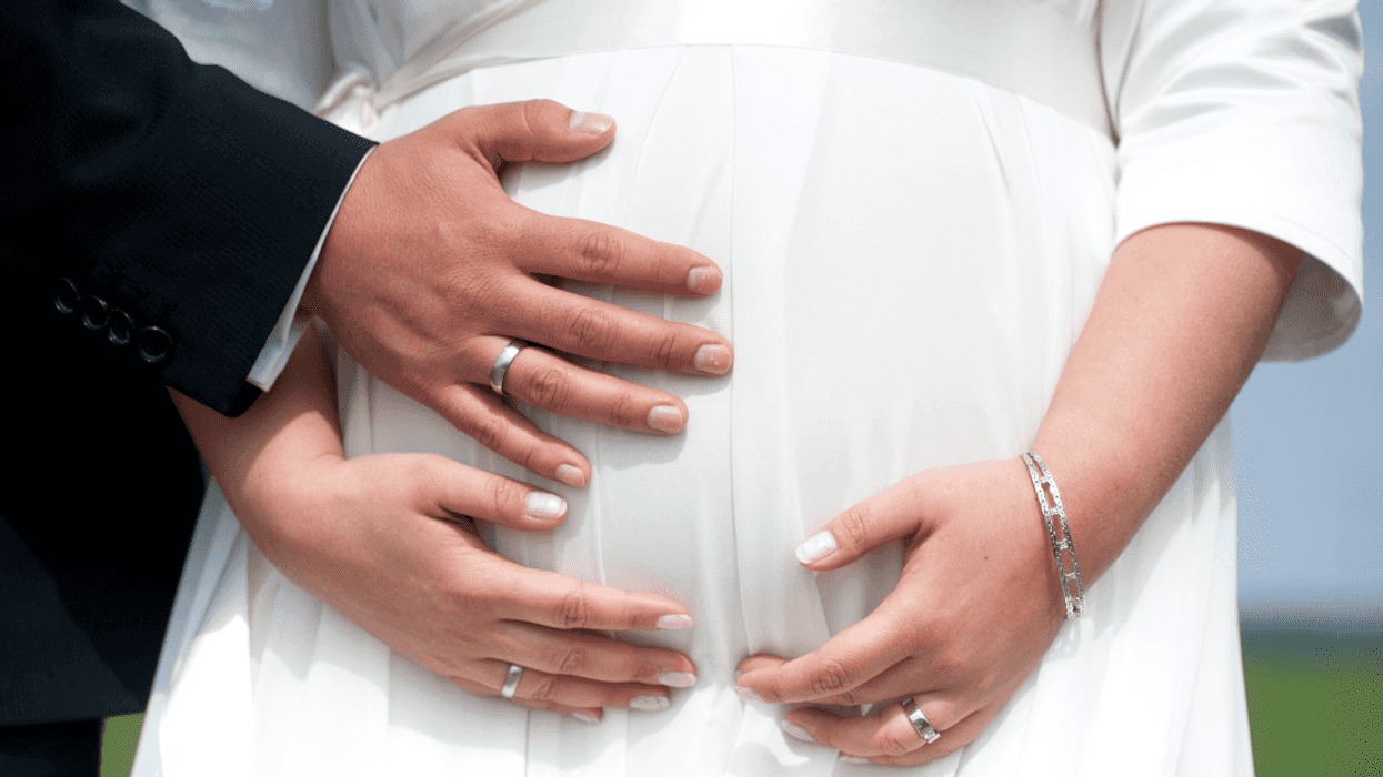 Pregnant bride with groom