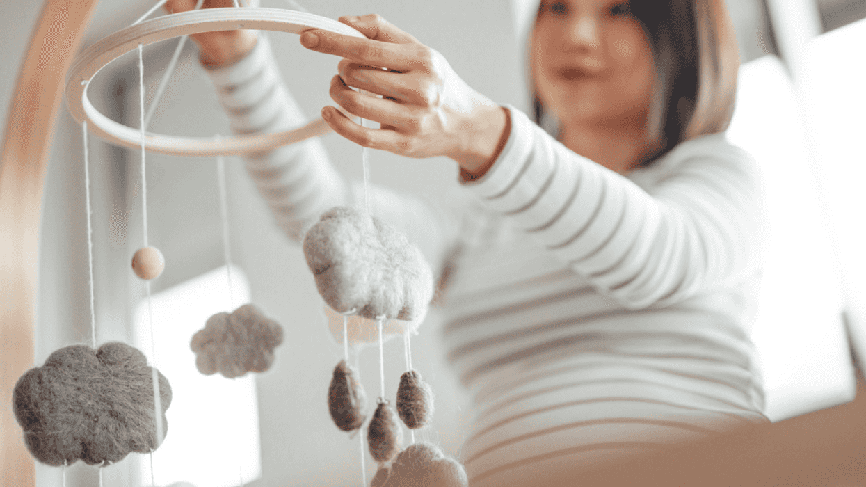 Pregnant mom arranging nursery